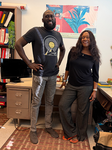 A smiling man and woman standing in a small colorful office. UC Davis Department of Plant Sciences