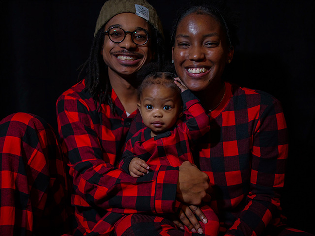 A family portrait showing a young man and woman, and a small child.