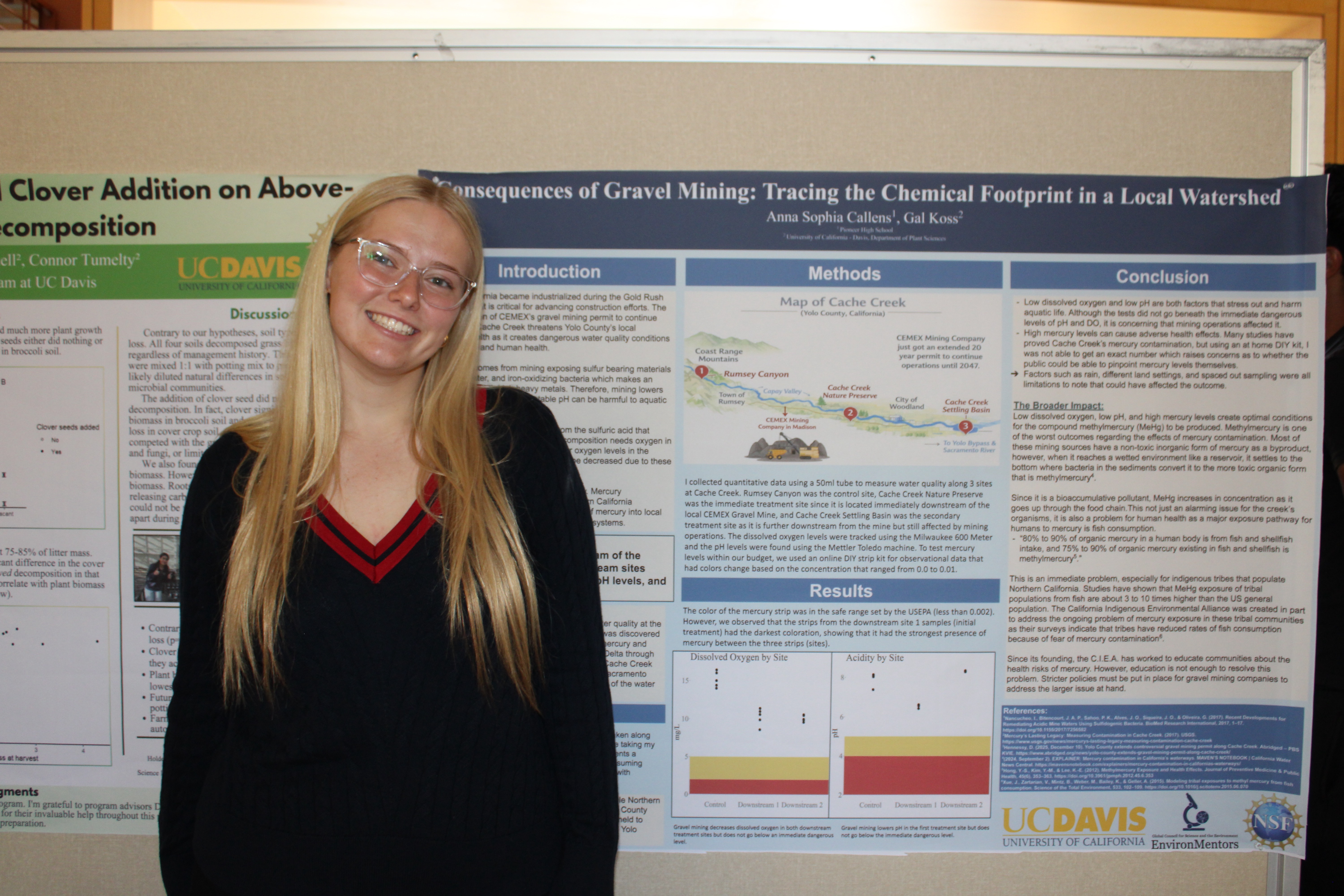 Young woman with long blond hair and glasses smiling in front of an academic poster. UC Davis Department of Plant Sciences