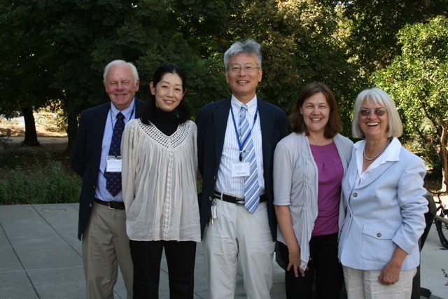Several people standing together and smiling.