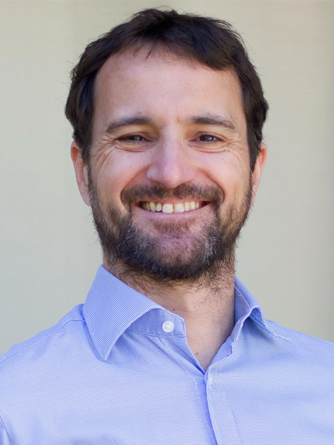 Man smiling in blue shirt