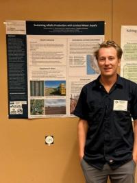 Man standing next to a research poster.