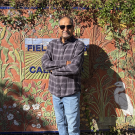 Dr. Ladha standing in front of an art piece